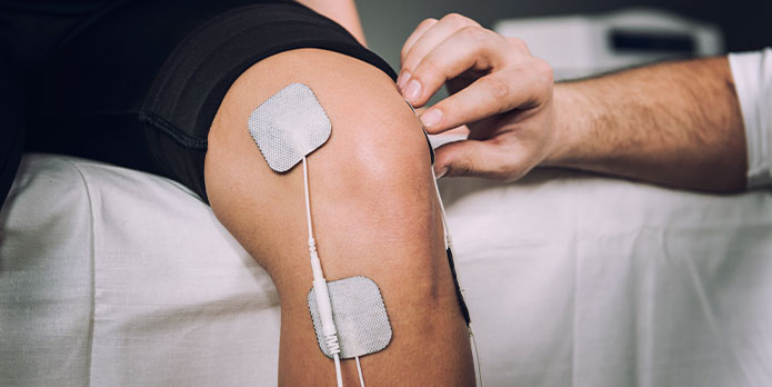 patient getting electrical muscle stimulation as an auto accident injury treatment in Pompano Beach
